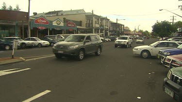 Long shot down main street in Byron Bay, shops and cars.