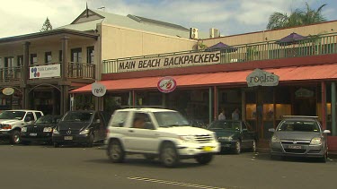 Main Beach Backpackers Byron Bay. main street in Byron Bay, shops and cars.
