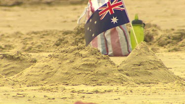 Beach sandcastle with Australian flag.