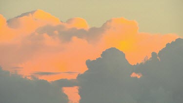 Clouds at sunset, pinks, light oranges. Clouds in shadow or silhouette.