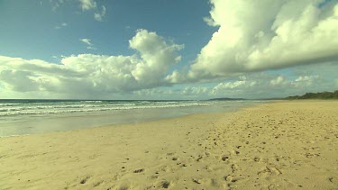 Empty beach with footprints on sand