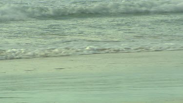 Gentle waves lapping onto beach