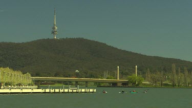 Australian Flag, Canberra, Lake Burley Griffith.Four people Kayaking on lake. Telecommunications tower in background