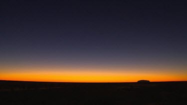 Uluru sunset, Very wide shot. Super Wide angle lens. Sunset sky red orange yellow blue, black