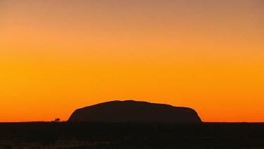 Uluru silhouette sunset. Red, yellow sunset sky