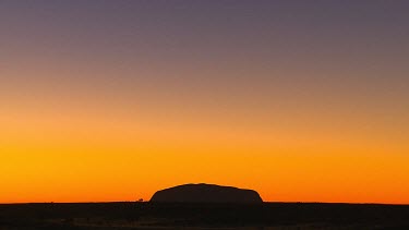 Uluru silhouette sunset. Red, yellow sunset sky