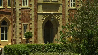 Close Up Doorway, gothic arch, tilt up to turrets. Government House Perth.