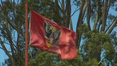Red Flag with official coat of arms of City of Perth two black swans. Blowing in the wind