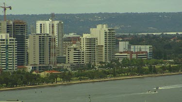 Perth. Buildings on bank of Swan River pan to Bell Tower. Swan Bells