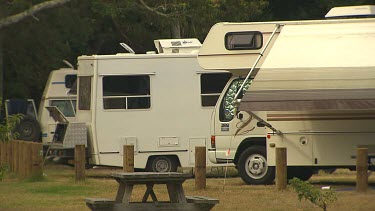 Row of caravan campervans parked in a campsite