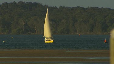 Sail boat approaches sand bar