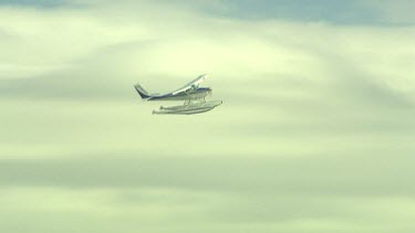 Seaplane flying across the sky.