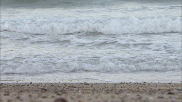 Waves lapping onto beach