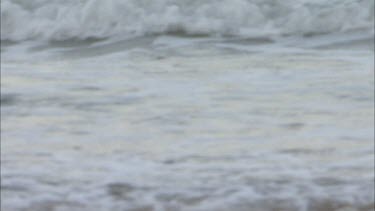 Waves lapping onto beach