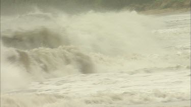 Storm. Rough seas. Waves crash onto beach.