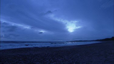 Wide Shot. Pebble beach in evening light. Sea and sky.