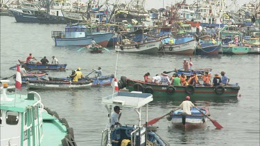 Very busy port in Ilo Peru. Rowing boats and fishing boats.