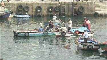 Very busy port in Ilo Peru. Man with row boat