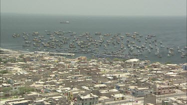 Port and city Peru. Fishing boats and container ships. Establishing Shot EST. High angle