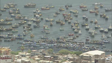 Port and city Peru. Fishing boats and container ships. Establishing Shot EST. High angle