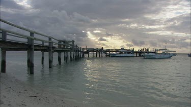 Pier jetty dock. Holidaymakers on tropical island disembark from boat