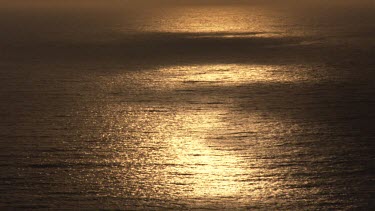 Shafts of light on ocean, dusk or dawn,