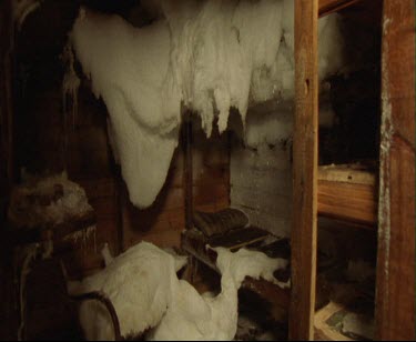 Details of interior of Mawson' s Hut. Cape Denison Commonwelath Bay. Beds, cots. All well preserved because of cold dry climate. Survival in extreme cold. Ice has frozen over everything.