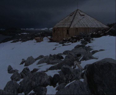 Mawson's Hut with darkened skies, nightfall or winter.