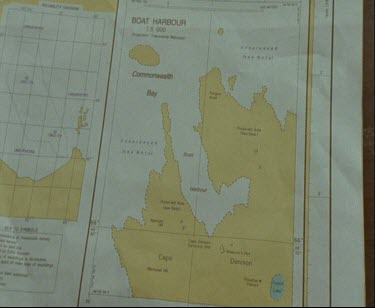 Hand pointing at map, chart of Commonwelath Bay, Australian Antarctic Territory.