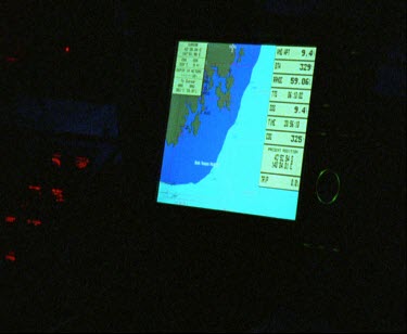 Inside bridge of ship at night. Radar and communication devices.