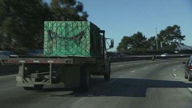 Tracking shot following truck on highway. Approaching San Francisco California.