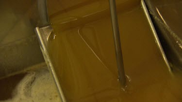 Honey factory pouring clarified honey.
