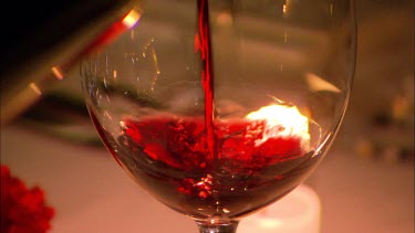 Red wine being poured into a glass aboard a luxury train