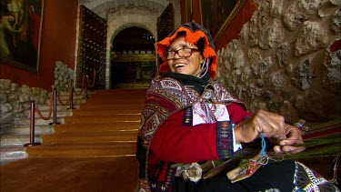 Tradtional Peruvisan weaver on the steps of a museum in Cuzco, Peru