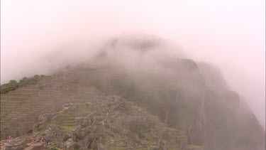 Time lapse of the stone terraces at a misty Machu Picchu