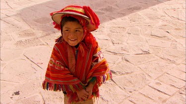 A young boy, a local of Ollantaytambo, acting bashful in front of the camera