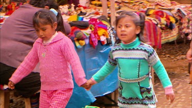 Two girls walking through a market