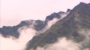 Mountain peaks rising up through the clouds