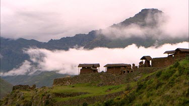 A mountain side village ruins in Peru