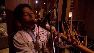 Peruvian musician playing the traditional flute in a luxury hotel