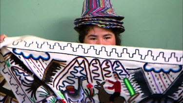 A peruvian woman shows off her arts and crafts
