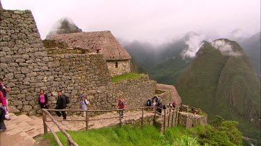 Tourists walking up a staircase in Machu Piccu