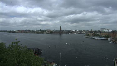 View over Riddarholmskyrkan and the turning NK sign in Stockholm, Sweden.