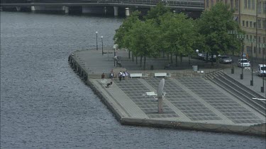 People by the waterfront, Riddarholmen. Stockholm, Sweden.