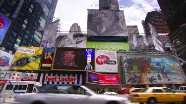 Times Square. Advertising LCD billboards. Broadway. Yellow New York cabs and traffic.