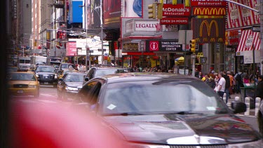 Very busy traffic, yellow cabs in New York, MacDonalds.