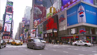 Times Square. Advertising LCD billboards. Broadway. Yellow New York cabs and traffic.