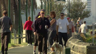Man walking dog , people walking and exercising in a park