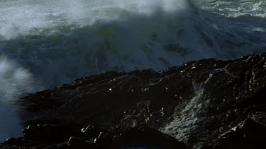 Wave crashing onto beach