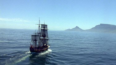 Tall historical sailing ship sailing towards Cape Town